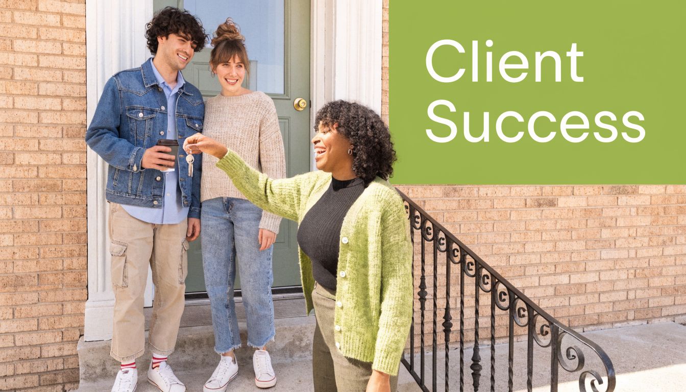 A real estate agent handing house keys to a happy young couple standing in front of home.